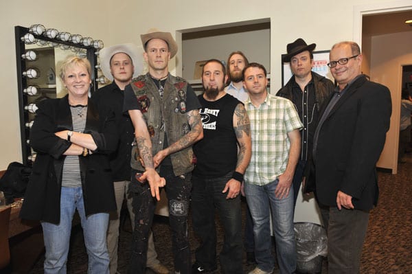 Pictured L-R—Exhibit co-curator Carolyn Tate, Daniel Mason (banjo), Williams, Shawn McWilliams (drums), Zach Shedd (bass), Adam McOwen (fiddle), Andy Gibson (steel guitar, dobro) and exhibit co-curator Michael McCall. Photo by Donn Jones