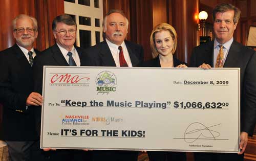 President/CEO of the Nashville Symphony Alan Valentine, Director of Metropolitan Nashville Public Schools Dr. Jesse Register, Chairman Elect of CMA's volunteer Board of Directors Steve Moore, BNA Recording Artist Kellie Pickler, and Mayor of Nashville Karl Dean present the proceeds from the 2009 CMA Music Festival during the "Keep the Music Playing" All-Stars Concert. CMA's "Keep the Music Playing" program funds music education in Metro Nashville in partnership with the Nashville Alliance for Public Education (NAPE).