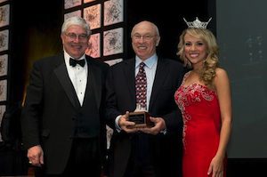 Pictured: Bill Carter (c) receives Crystal Award from  Richard W. Davies,Executive Director, Arkansas Department of Parks and Tourism (l) and Sloane RobertsMiss Arkansas 2012 (r). 