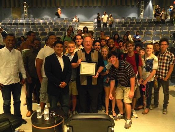 Gary Overton, who holds the plaque commemorating his designation as Honorary Professor, is surrounded by MTSU students after his talk on campus.