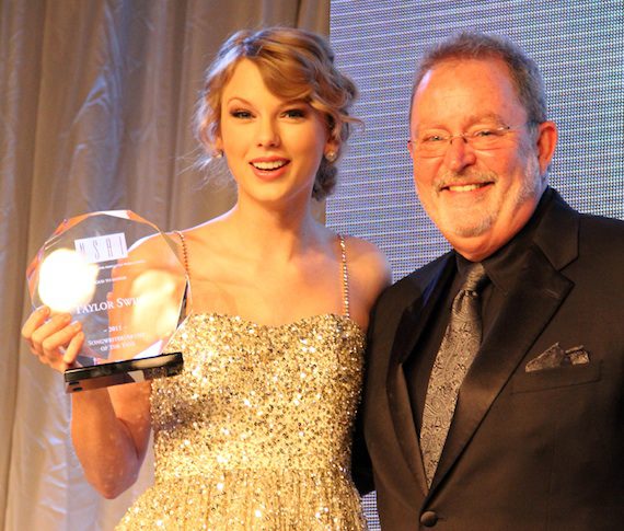 Taylor Swift accepts her Songwriter/Artist of the Year trophy from NSAI in 2011.