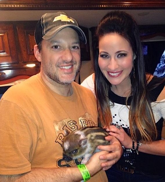 Pictured: Chelsea Bain (r.) visits with NASCAR Sprint Cup great Tony Stewart (l.) and his new pet piglet “Pork Chop” in Stewart’s motor coach prior to the final race of the NASCAR season at Homestead-Miami Speedway on Sunday.