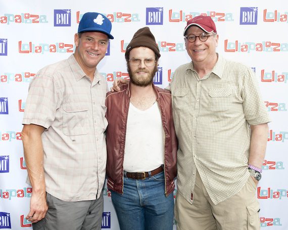 BMI Executive Director, Writer-Publisher Relations Mark Mason (left) and BMI Vice President, Writer-Publisher Relations Charlie Feldman (right) flank Fly Golden Eagle’s Ben Trimble backstage at Lollapalooza.