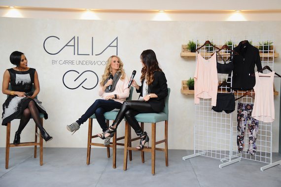 Carrie Underwood with emcee Alicia Quarles and DICK's Sporting Goods designer Alycia Scott at press event in New York City for the unveiling of CALIA by Carrie Underwood 