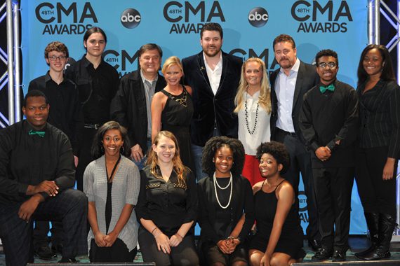 Students from the Hillsboro High School choral group after performing at the CMA Awards radio remotes Nov. 2 in Nashville. Pictured (L-R): (back row, third from left) CMA Foundation Board member Lon Helton; CMA Senior Director of Membership and Balloting Brandi Simms; CMA Board member Chris Young; CMA Community Outreach Manager Tiffany Kerns; and CMA Board member Rob Beckham. Photo: Scott Hunter.