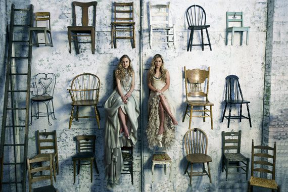 Pictured: (L-R): Maddie & Tae sit high atop a wall of chairs while filming “Fly.” Photo: Joseph Llanes