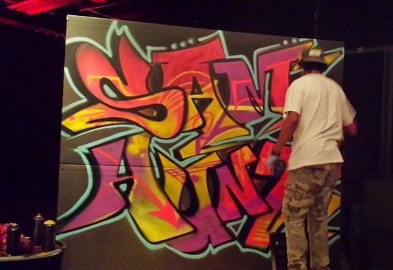 A graffiti artist at work during the party. 