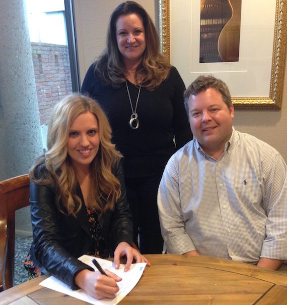  Pictured (seated, L-R): SaraBeth, and BMI’s Senior Director, Writer-Publisher Relations Bradley Collins. Standing: Verge Management’s Nancy Eckert