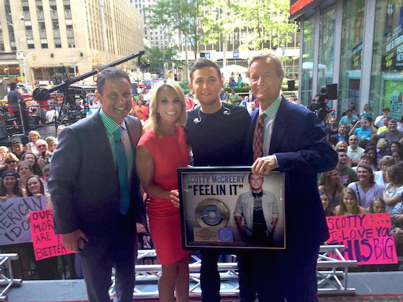 Scotty McCreery received a Gold Record for his single "Feelin' It" after his "FOX & Friends" All-American Summer Concert Series performance on July 31. Pictured (left to right): "FOX & Friends" hosts Brian Kilmeade and Elisabeth Hasselbeck, McCreery, and "FOX & Friends" host Steve Doocy  Credit: Scott Stem