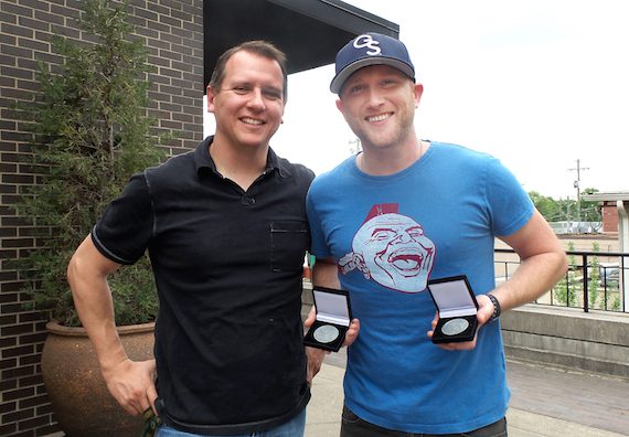 MusicRow's Troy Stephenson presents Cole Swindell with two MusicRow Challenge Coins for co-writing "This Is How We Roll" and "Roller Coaster."