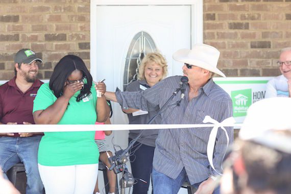 Alan Jackson hands the keys to new Rutherford County Area Habitat homeowner Keosha Hendricks and her daughter Akori' Yahah