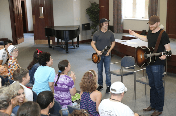 Ross Copperman (L) and Eric Paslay (R) work with campers to write a song. Photo: Getty Images