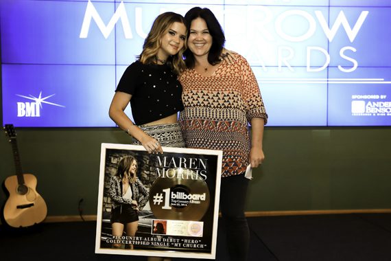 Big Yellow Dog’s Carla Wallace (R) surprises her writer Maren Morris (L) with a plaque commemorating a No. 1 country album debut, along with its lead single achieving gold. Photo: Moments By Moser Photography