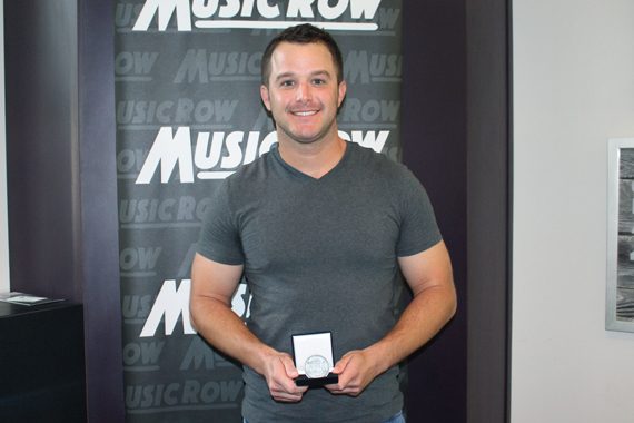Easton Corbin accepts his MusicRow No. 1 Challenge Coin for "Baby Be My Love Song."