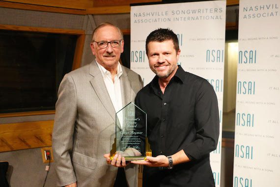 Elwyn Raymer (President of CMPA) accepting the NSAI President's Choice Award; NSAI President Lee Thomas Miller 