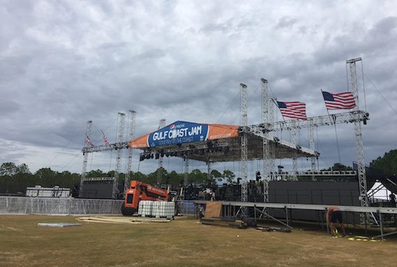 Crew works hard to strike the stage as winds begin to blow. 