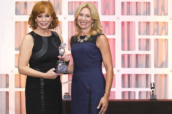 Reba McEntire accepts her Women In Music City Award from Nashville Business Journal Publisher Kate Herman.